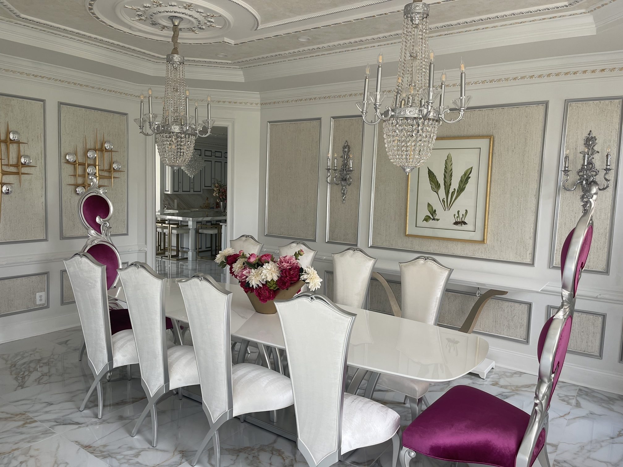 The Magenta Dining Room: statement velvet host chairs, crystal chandeliers, botanical art, designed and furnished by John Hashempour